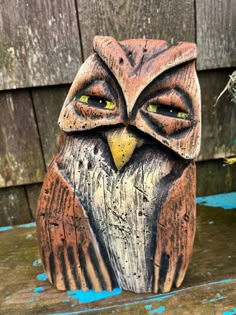 an owl statue sitting on top of a wooden table