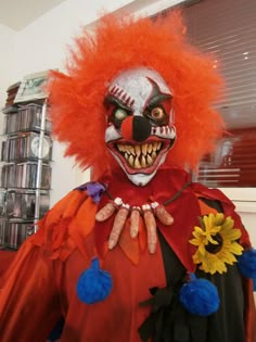 a clown with orange hair and red makeup