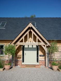 a house with two large planters in front of it and a door on the outside