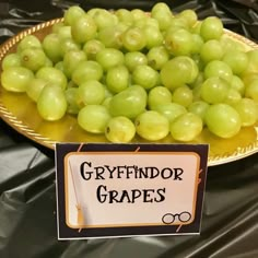 a plate with grapes on it and a sign that says gyrfindor grapes