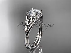 a white gold engagement ring with an intricate design