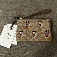 Brand New Mickey Mouse Coach Wristlet Comes With Coach Box And Tissue Paper Brown Rectangular Bags With Wrist Strap, Coach Brown Bag As Gift, Coach Brown Bag For Gift, Coach Brown Bag As A Gift, Brown Wristlet With Removable Pouch As Gift, Brown Pouch Wristlet For Travel, Brown Clutch Wristlet For Travel, Brown Coach Pouch Clutch, Coach Brown Wristlet With Zipper Closure