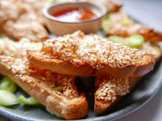 sesame seeds are sprinkled on top of the breaded pastries with dipping sauce