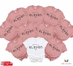 a bunch of pink onesuits with the words eleven printed on them