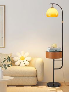 a living room with a white couch and yellow lamp on the table next to it