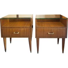 a pair of nightstand tables with glass tops