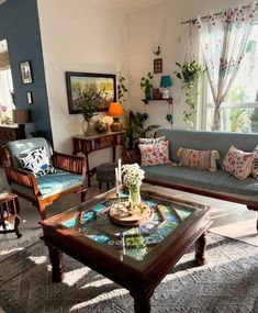 a living room filled with lots of furniture next to a wall mounted clock and window