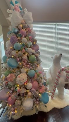 a christmas tree decorated with pastel colors and candy canes