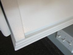 a close up view of a white cabinet door