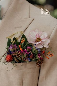 a man in a suit with flowers on his lapel