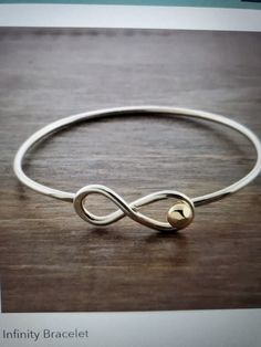 The Infinity bracelet is simple and elegant. Made from Silver and 14K gold the infinity stands alone or compliments other pieces Items are hand made and some variations may occur The Infinity, Infinity Bracelet, Arm Band, Cuff Bracelets, Jewelry Bracelets, Hand Made, Etsy Accessories, Accessory Gift, Gift Card