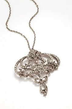 "This delicate Art Nouveau inspired pendant is suspended from a delicate brass link chain,  all plated in Rhodium with a soft antique finish. Rhodium plating resists tarnish, use a soft cloth to refresh. Hand set with European crystals, the necklace adjusts from 16\" to 19\" in length. Lobster claw closure. Pendant is 1.75 inches long by 1.75 wide. Made In America This listing is for one necklace. Please read our terms, conditions and shipping information located in Policies before committing to Bijoux Art Nouveau, Art Nouveau Pendant, Art Deco Dress, Vintage Soul, Art Nouveau Jewelry, Silver Art, Inspiration Art, Antique Finish, Made In America