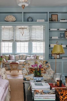 a living room filled with furniture and bookshelves