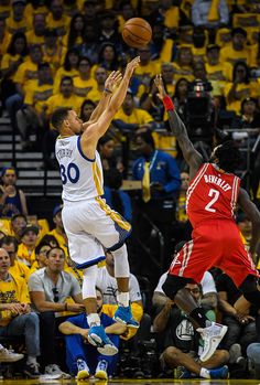 two men playing basketball in front of an audience