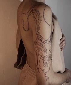 a man with a dragon tattoo on his back