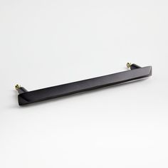 a black shelf with two brass handles on it