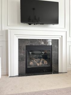 a flat screen tv mounted above a fireplace