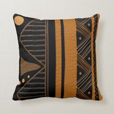 a decorative black and gold pillow with an abstract design on the front, along with a white background