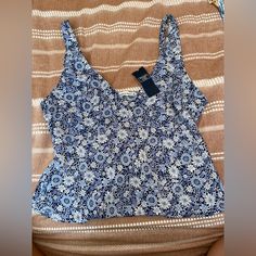 Blue Tank With Floral Print. Size Medium Casual Blue Printed Tank Top, Blue Printed Sleeveless Top, Navy Summer Tops For Vacation, Blue Printed Tank Top For Vacation, Blue Floral Print Tank Top For Vacation, Blue Printed Tank Top For Summer, Navy Fitted Summer Top, Fitted Blue Printed Tops, Navy Sleeveless Top For Vacation