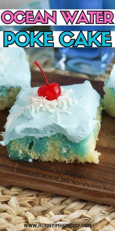 a piece of ocean water poke cake on a cutting board with a cherry in the middle