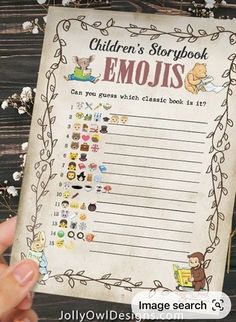 someone holding up a children's storybook emojs