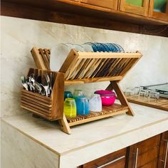 a kitchen counter with wooden utensils and dishes on it's trays