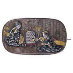 This exquisite antique Japanese shakudo rectangular brooch is a fine example of Japanese mixed metalwork from the Meiji period (1868-1912). The brooch is crafted using a combination of metals including gold, silver and copper, materials used in a Meiji period known for exceptional craftsmanship and unique designs. The brooch is made using a shakudo technique. The central design features a scene with a pair of geisha sitting on the floor, one of them is feeding a quail (uzura), popular Japanese m Ceremonial Enamel Brooch Jewelry, Vintage Gold Intaglio Brooches, Victorian Pendant Necklace, Art Nouveau Silver, Art Nouveau Pendant, Meiji Period, Romantic Scenes, Gold Locket, Antique Brooches