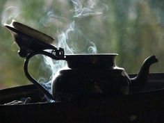 a tea pot with steam coming out of it