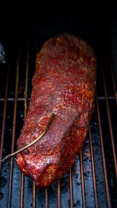 a piece of meat is cooking on the grill