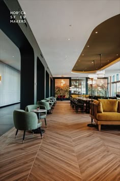 an empty restaurant with wooden floors and yellow chairs