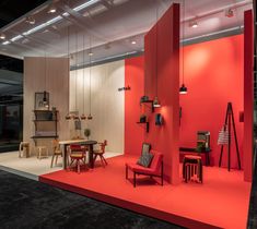 a red room with chairs and tables on display