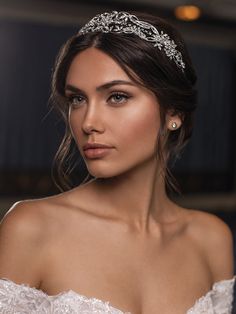 a beautiful woman wearing a tiara and posing for the camera