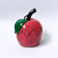 a red apple with a green leaf on it