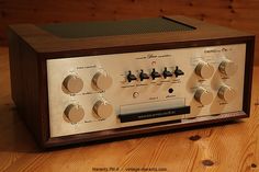 an old radio sitting on top of a wooden table