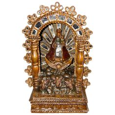 an ornately decorated wooden statue on white background