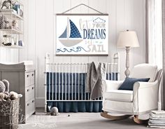 a baby's room with a white rocking chair and whale prints on the wall