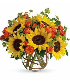 sunflowers and roses in a glass vase