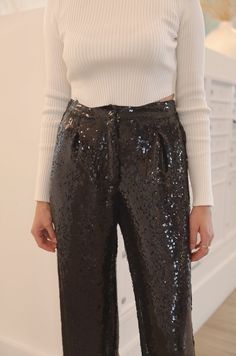 These black sequin pants are the perfect combination of style and comfort. The high waist and elastic waistband make them comfortable to wear while the wide leg gives you a relaxed fit. The luxurious sequins add an extra touch of elegance. black sequins high waist stretchy waist button and zipper closure relaxed wide leg true to size model is wearing a medium Sequin Pants Outfit Black, Black Sequin Pants Outfit, Sequin Pants Outfit, Sequins Pants Outfit, Sequin Wide Leg Pants, Curvy Date Night Outfit, Black Sequin Pants, Air Clothes, Sequin Flare Pants