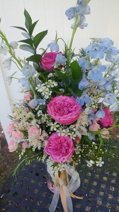 a vase filled with pink and blue flowers