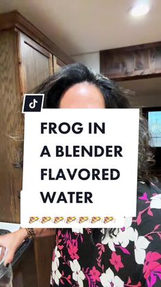 a woman holding up a sign that says frog in a blender flavored water