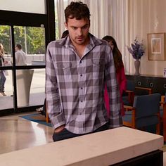 a man standing next to a counter in a room