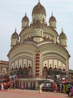 a large building with many people standing around it