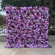 purple flowers are arranged in the shape of a square piece of art that looks like it is made out of wood