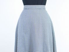 Item Description This is a gorgeous 90s cotton check skirt by Apostrophe! I absolutely love how the check pattern is made up of both white and black, and so it has a nice light gray tone when looking at it from far away. This skirt has an a-line almost circle skirt shape with a gorgeous high rise, and pockets!! Such a classic and timeless piece with a super flattering fit, that will be versatile for styling. I love the extra buttons on the waistband. They have a super cute look as they are, and Chic Fitted Houndstooth Skirt, Plaid Full Skirt For Work, Fitted Plaid Midi Skirt, Plaid Skirt For Summer Workwear, Plaid Workwear Skirt For Summer, Spring Plaid Skirt For Work, Chic Fitted Plaid Skirt, Spring Gingham Skirt For Workwear, Plaid Cotton Skirt For Work