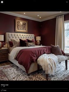 a bedroom with a large bed and red walls