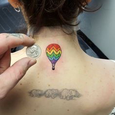 a woman with a colorful hot air balloon tattoo on her back