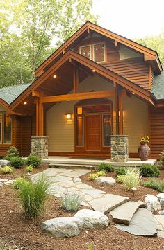 a large wooden house sitting in the middle of a forest