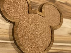 a wooden mickey mouse cut out on top of wood