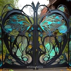 an ornate iron gate with blue butterflies on it