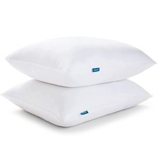 two pillows sitting side by side on top of each other, one is white and the other is blue